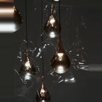 Mirrored Teardrop Five-Light Linear Pendant, close-up of shades in a dark setting