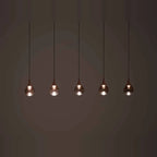 Mirrored Teardrop Five-Light Linear Pendant, lit in a dark room