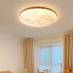 Moon flush ceiling light with a wood-effect rim, in a bright bedroom