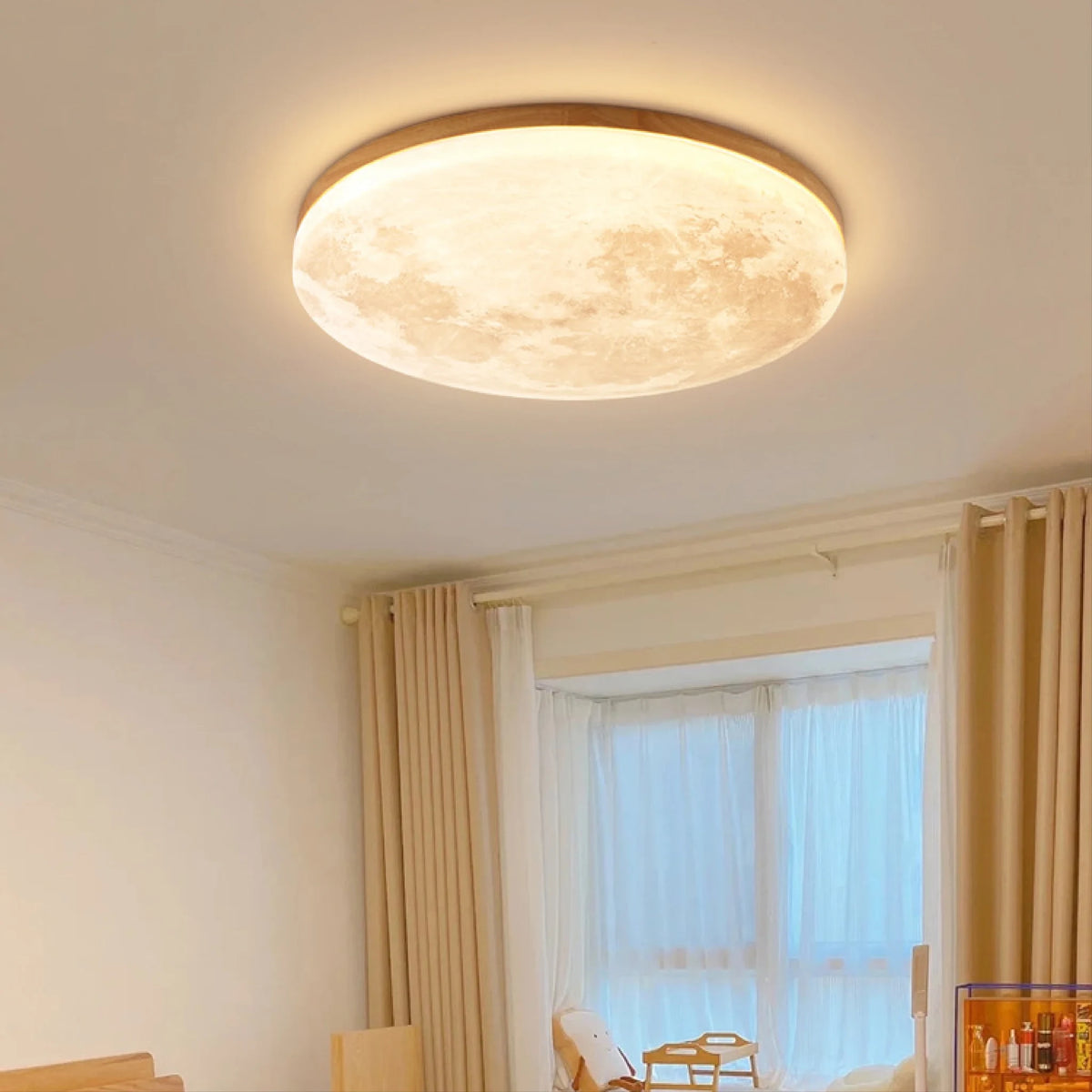 Moon flush ceiling light with a wood-effect rim, in a bright bedroom