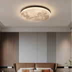 Moon flush ceiling light with a wood-effect rim, above a bed