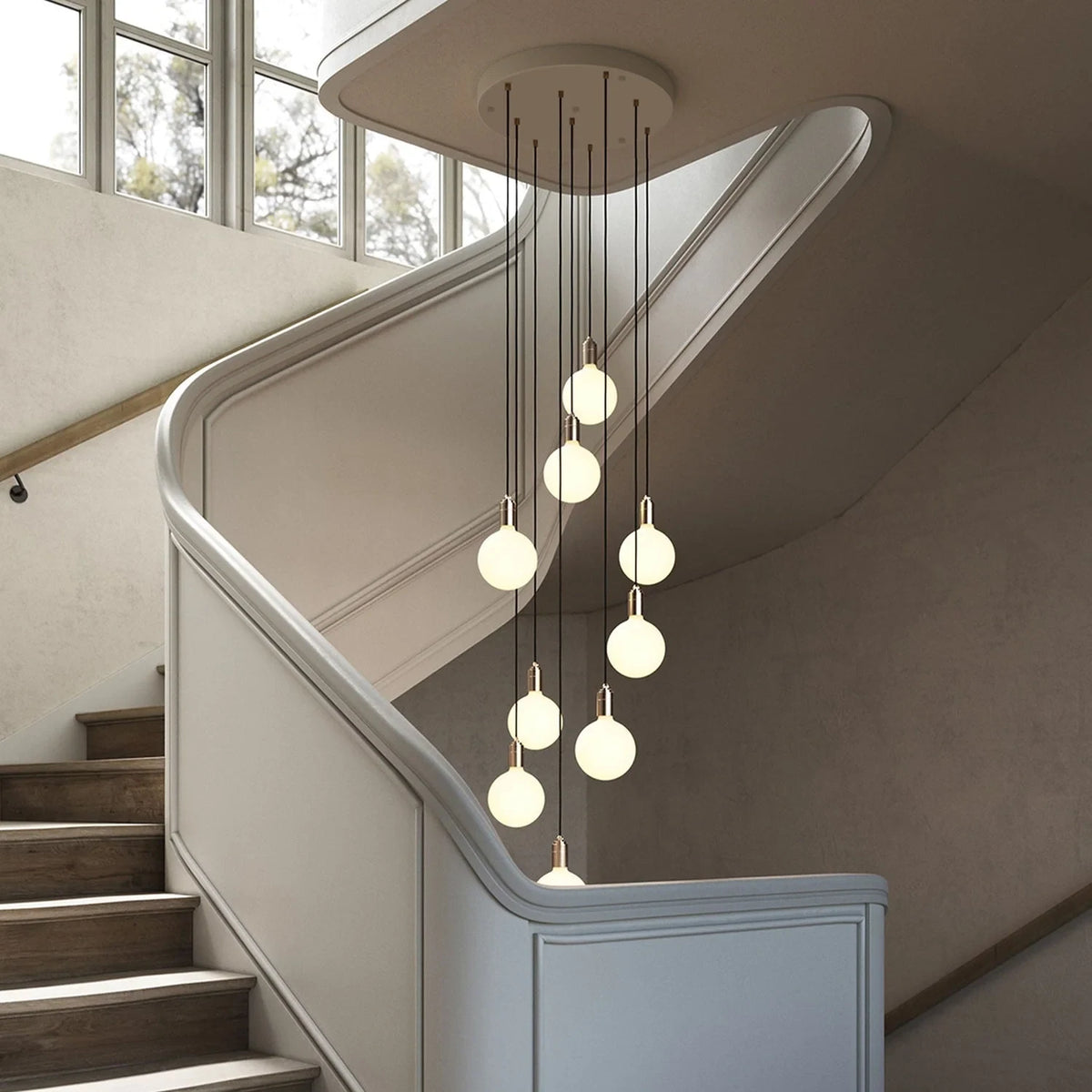 Nine-drop cluster pendant, in a stairwell with opal globe bulbs