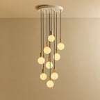 Nine-Drop Cluster Pendant, opal globe bulbs, oak, lit, nine opal globes at staggered heights