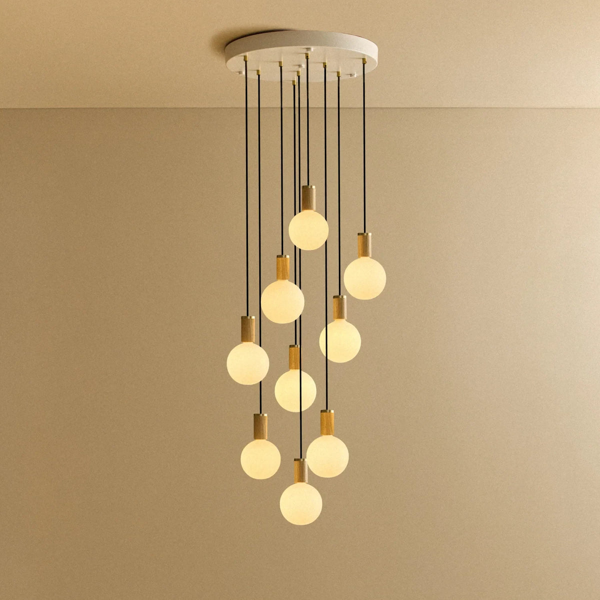 Nine-Drop Cluster Pendant, opal globe bulbs, oak, lit, nine opal globes at staggered heights