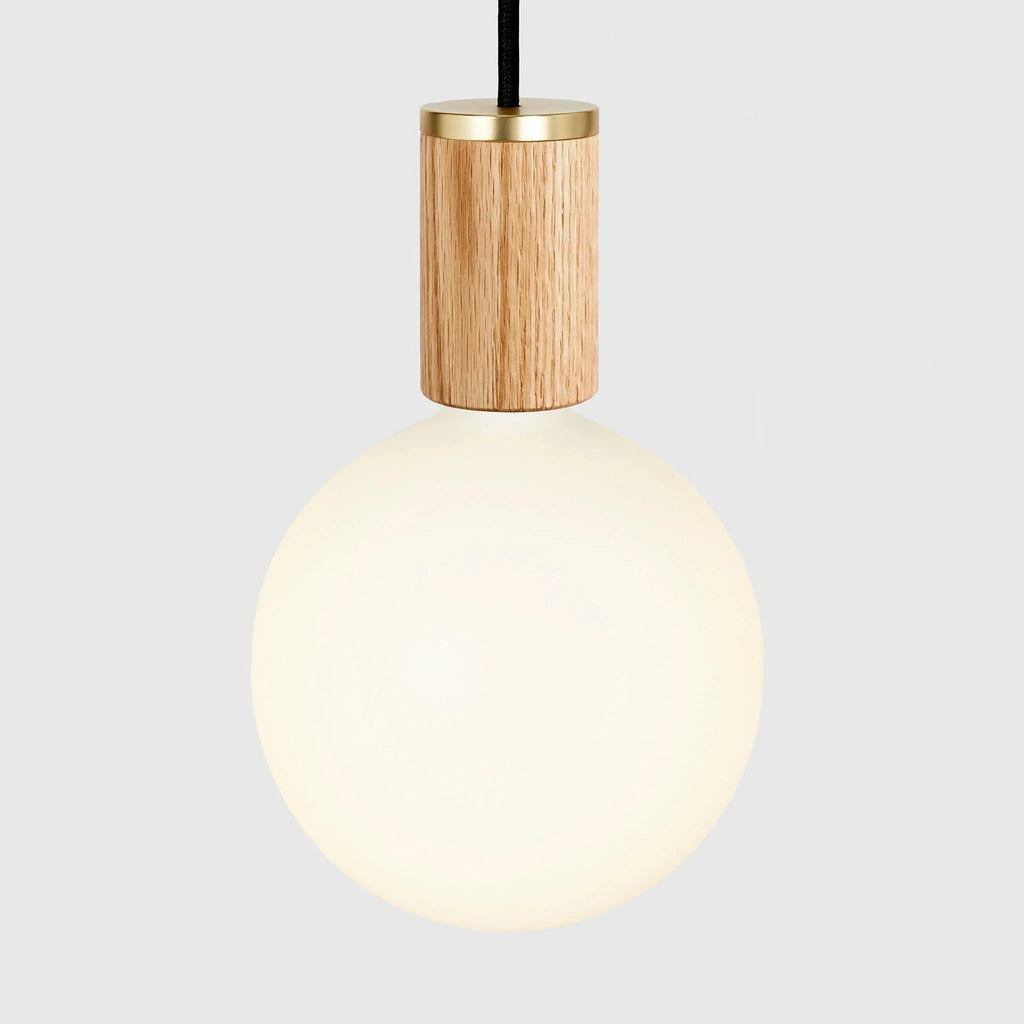 Nine-Drop Cluster Pendant, opal globe bulbs, oak, close-up of a globe on an oak holder