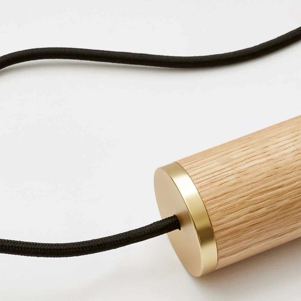 Nine-Drop Cluster Pendant, opal globe bulbs, oak, close-up of the oak holder and brass trim