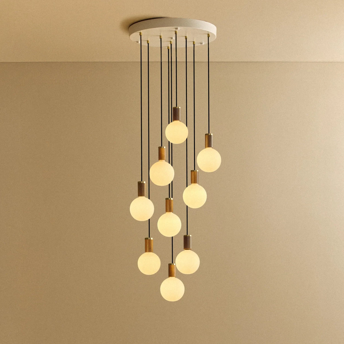 Nine-Drop Cluster Pendant, opal globe bulbs, walnut, lit, nine opal globes at staggered heights