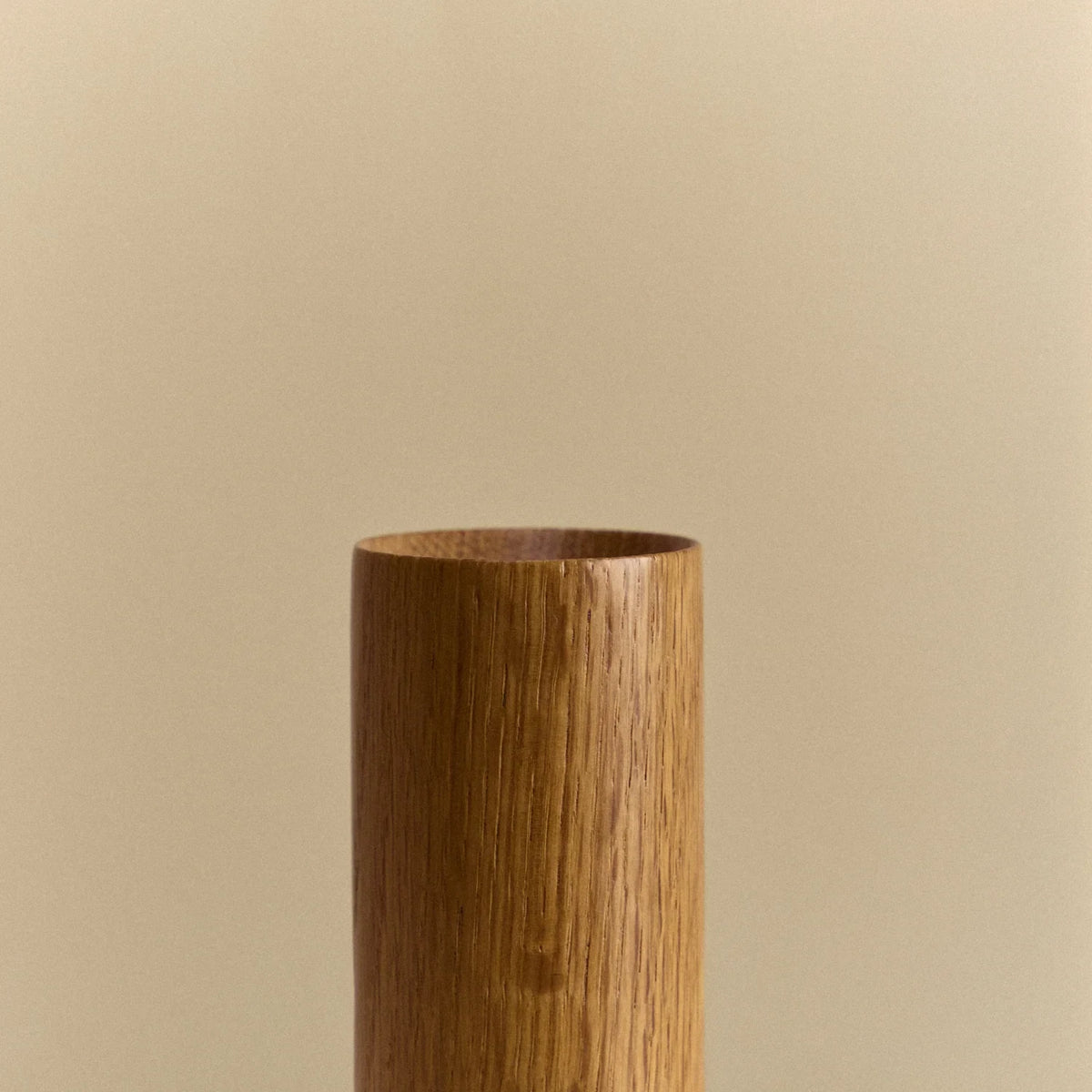 Oak cylinder table lamp with flared bulb, close-up of the open top of the wooden body