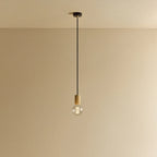 Oak cylinder pendant with filament LED bulb, against a plain wall