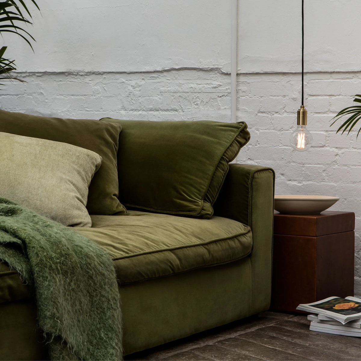 Oak cylinder pendant with filament LED bulb, beside a sofa