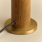 Solid oak table lamp, oval dim-to-warm bulb, close-up of the brass base and cable