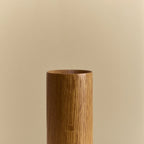 Solid oak table lamp, oval dim-to-warm bulb, close-up of the wooden cylinder