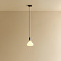 Opal Cone Bulb Pendant, in graphite, lit, against a plain wall