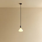 Opal Cone Bulb Pendant, in graphite, lit, against a plain wall