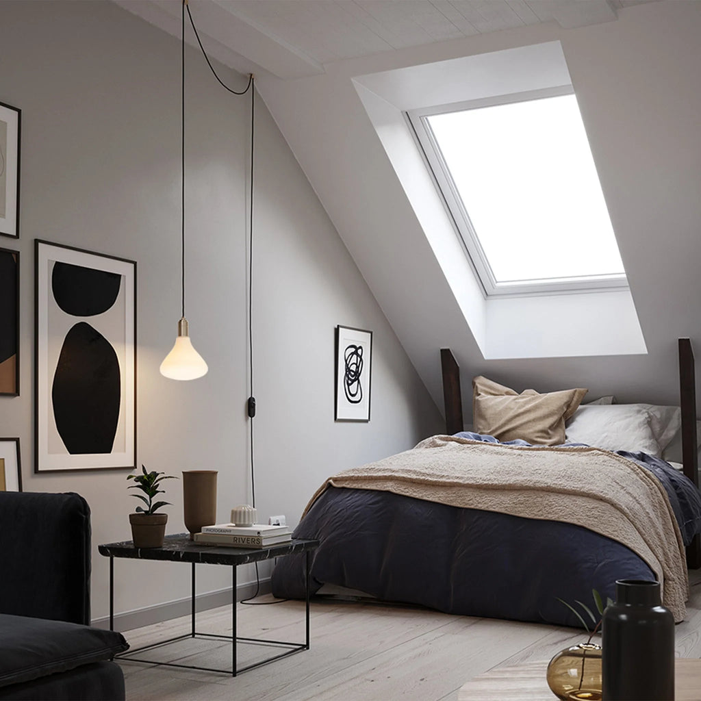 Opal cone bulb plug-in pendant, beside a bed in a loft bedroom