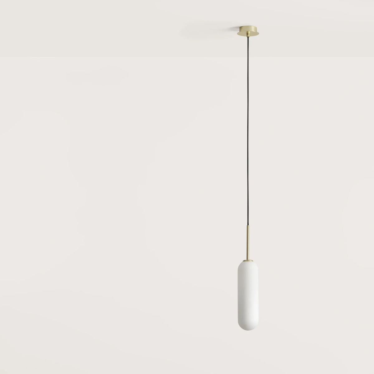 Opal glass capsule pendant, with matte brass canopy