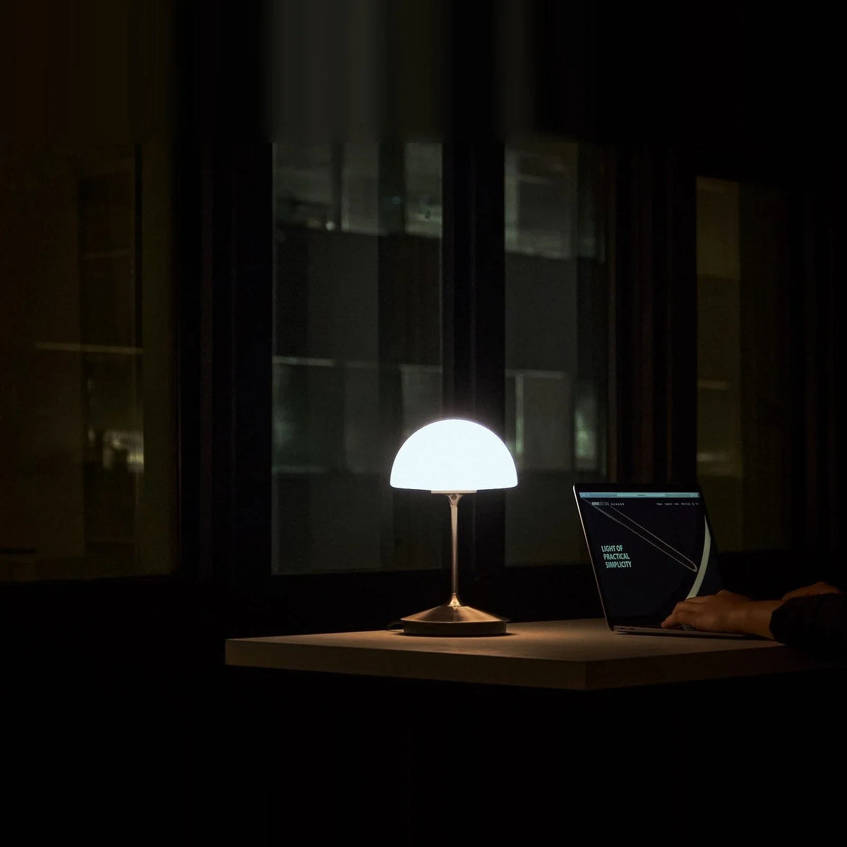 Opal glass dome table lamp with dimmer, lit on a desk with a laptop