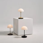 Opal glass dome table lamp with dimmer, three lamps on a white plinth