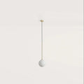 Opal glass globe pendant, with brass stem on a plain background
