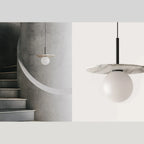 Opal globe disc pendant, with a stone-look disc in a stairwell
