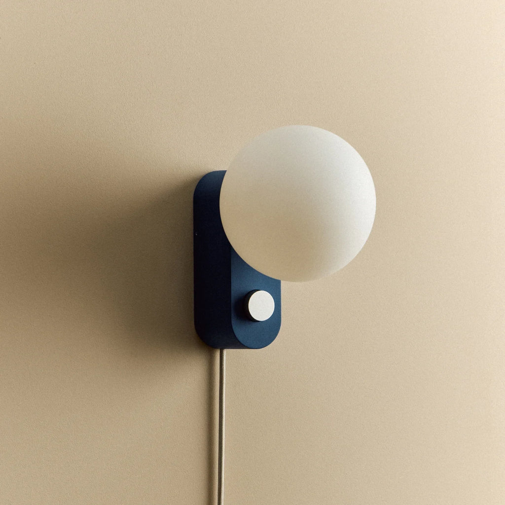 Opal globe table lamp with wall mount option, Sapphire, mounted on a wall, unlit