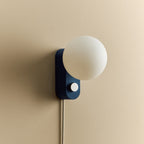 Opal globe table lamp with wall mount option, Sapphire, mounted on a wall, unlit