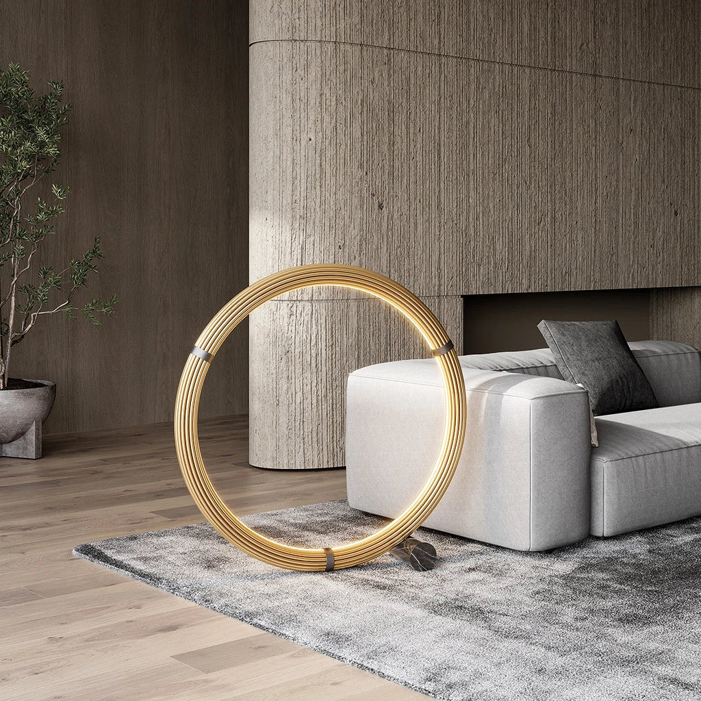 Circular opal ring floor lamp, matte black, lit, beside a sofa in a living room