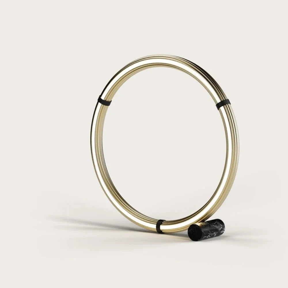 Circular opal ring floor lamp, matte black, lit, on a plain background