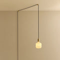 Opal rounded bulb plug-in pendant, routed across the ceiling and down the wall