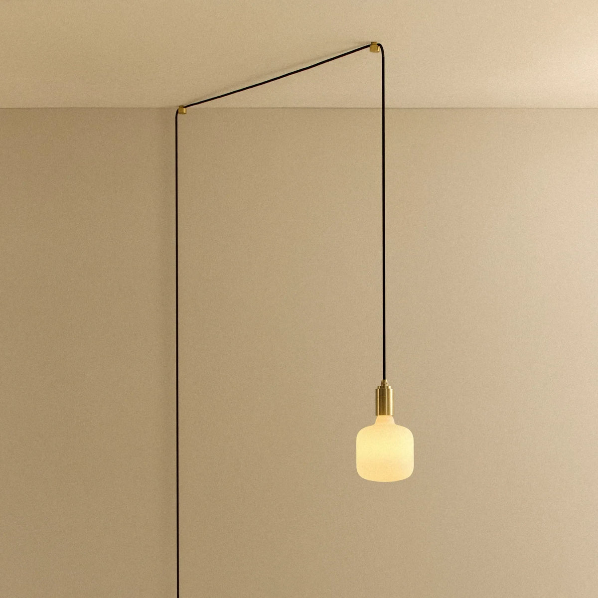 Opal rounded bulb plug-in pendant, routed across the ceiling and down the wall