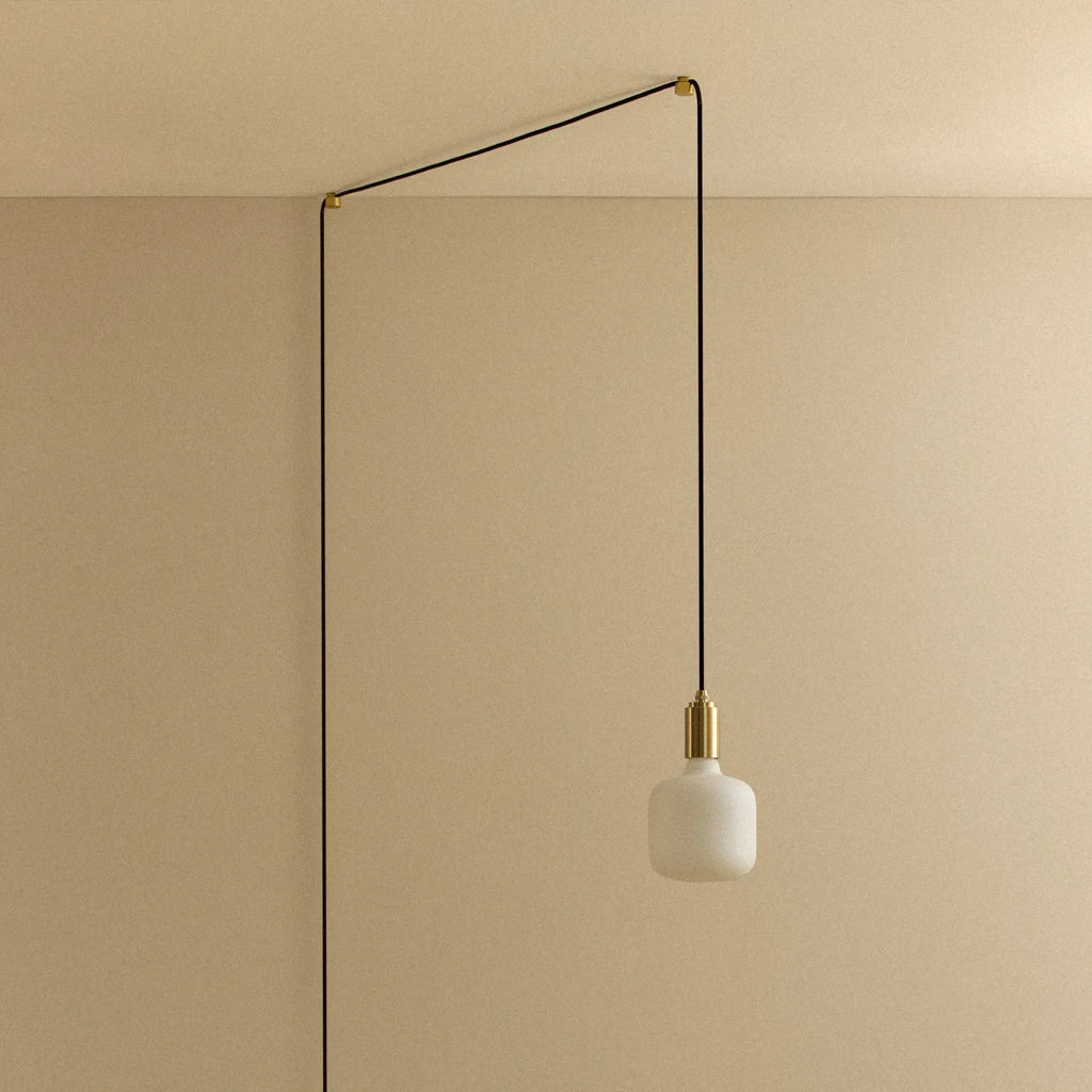Opal rounded bulb plug-in pendant, against a plain wall