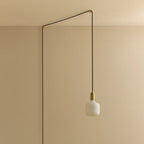 Opal rounded bulb plug-in pendant, against a plain wall