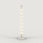 Eight-sphere opal glass floor lamp with a marble base, on a plain background