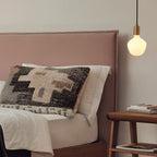 Opal trapezoid bulb plug-in pendant, beside a bed