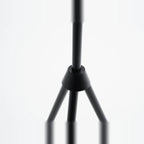Oversize shade tripod floor lamp with black steel tripod, close-up of the tripod joint