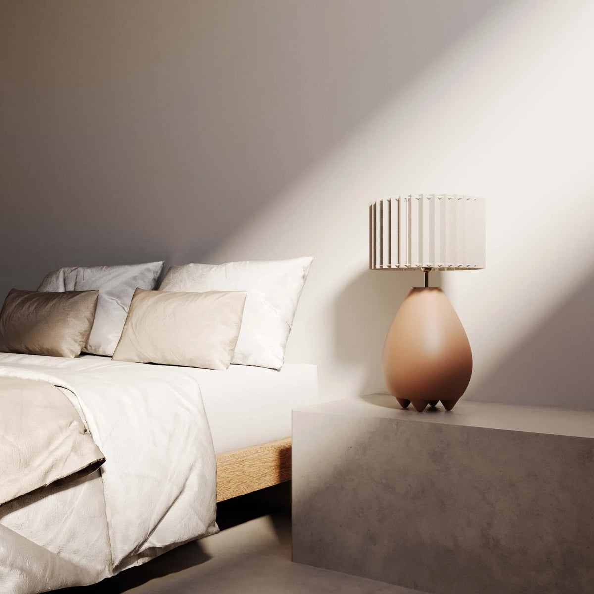 Pear-shaped ceramic table lamp with pleated shade, beside a bed
