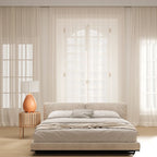 Pear-shaped ceramic table lamp with pleated shade, in a bedroom with tall windows