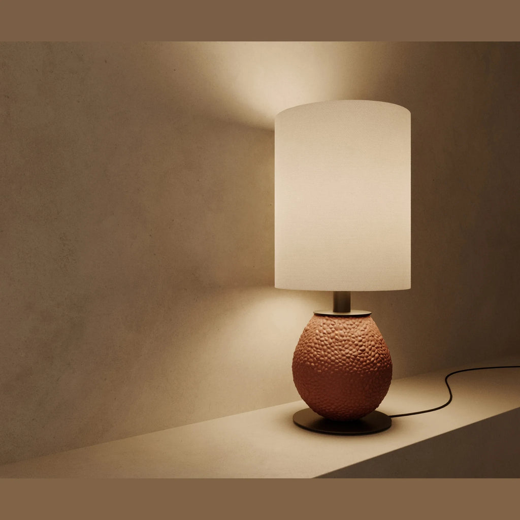 Pebbled ceramic egg-shaped table lamp base, in terracotta, lit, with a shade (sold separately)