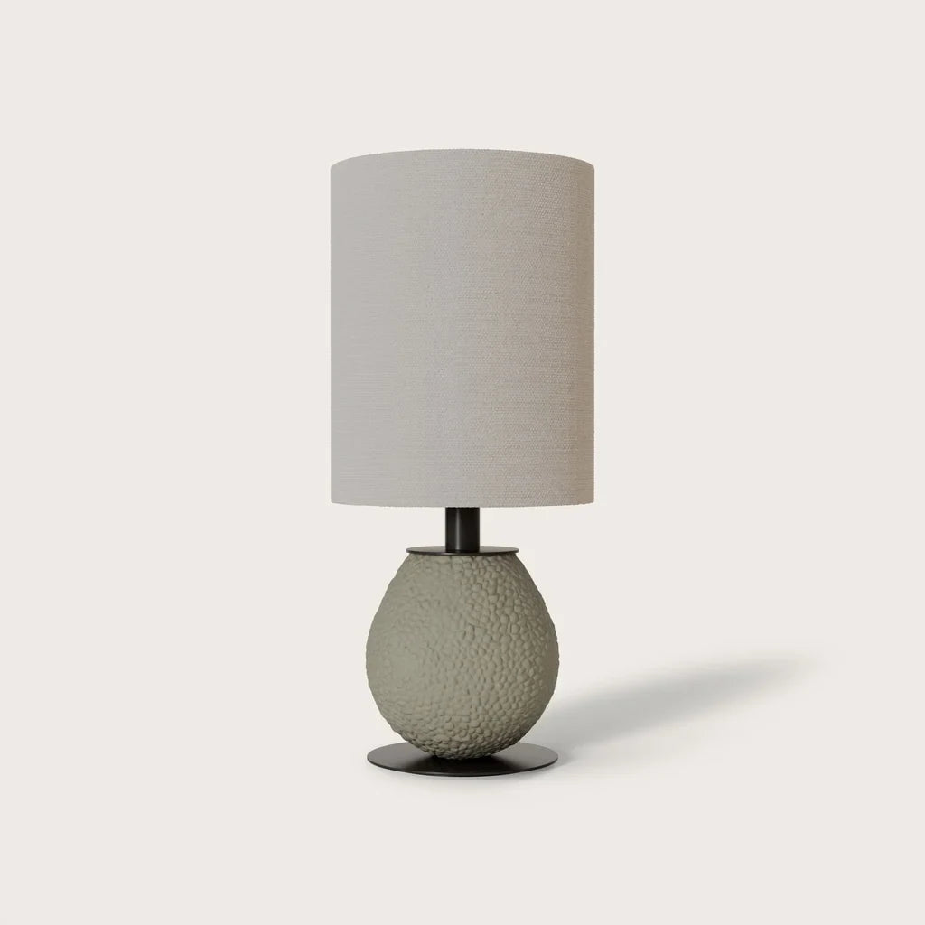 Pebbled ceramic egg-shaped table lamp base, in grey-green, shown with a drum shade (sold separately)