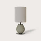 Pebbled ceramic egg-shaped table lamp base, in grey-green, shown with a drum shade (sold separately)