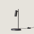 Pivoting spotlight table lamp with leather and ribbed metal head, in matte black