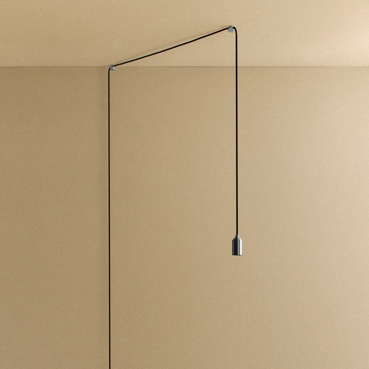 Plug-in bulb holder pendant, routed across the ceiling and down the wall