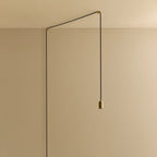 Plug-in brass pendant, cable routed across wall and ceiling