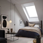 Plug-in brass pendant, beside a bed under a sloping ceiling
