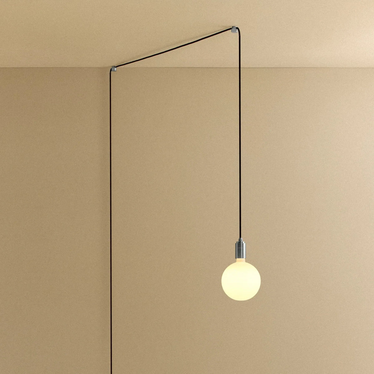 Plug-in pendant with opal globe bulb, stainless steel, cable routed across wall and ceiling