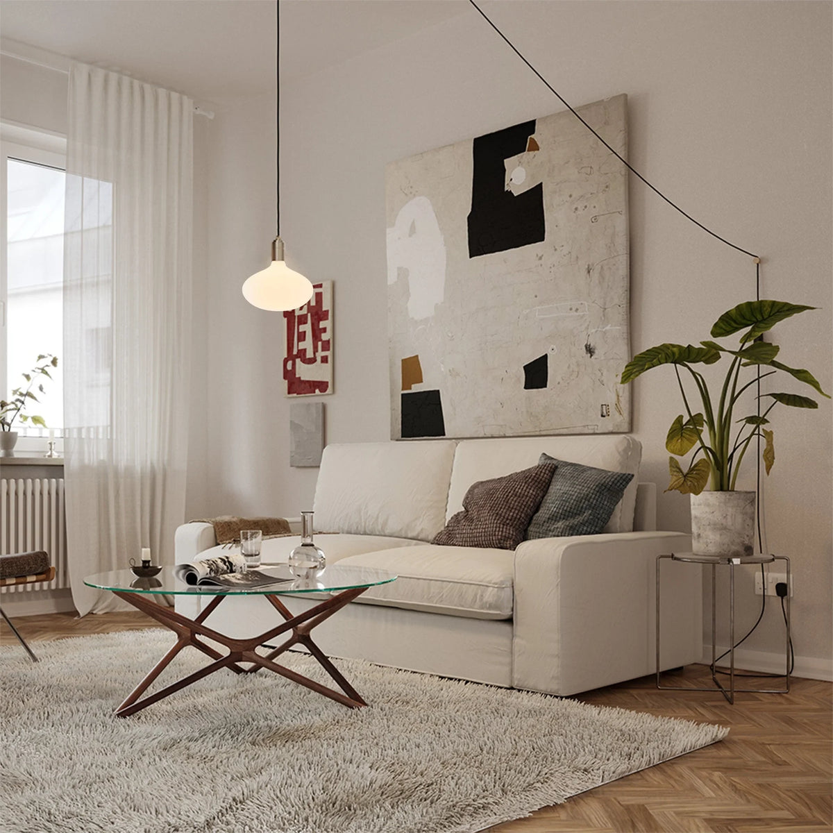 Plug-in pendant with opal oval bulb, brass, in a living room