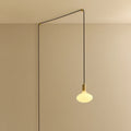 Plug-in pendant with small opal oval bulb, brass, cable routed across wall and ceiling