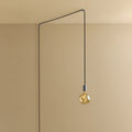 Plug-in pendant with small tinted sculptural bulb, stainless steel, cable routed across wall and ceiling