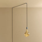 Plug-in pendant with tinted sculptural bulb, stainless steel, cable routed across wall and ceiling