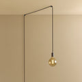 Plug-in pendant with tinted glass globe bulb, graphite, lit, hung from a wall node
